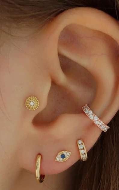 "Femme portant le Piercing Oreille Oeil en finition dorée"