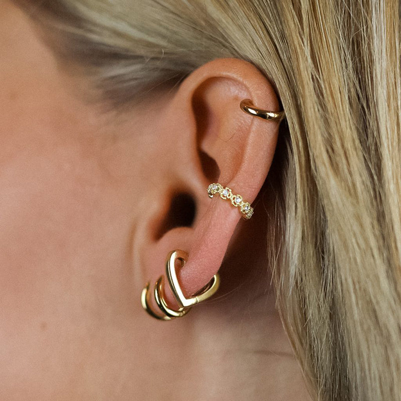 "Piercing Anneau Cœur porté sur une oreille féminine."
